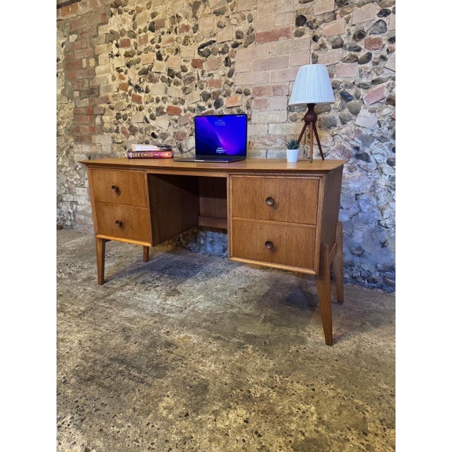 Great example of a small oak mid-century kneehole desk. Designed and produced by Meredew C1960. Stamped inside top drawer....