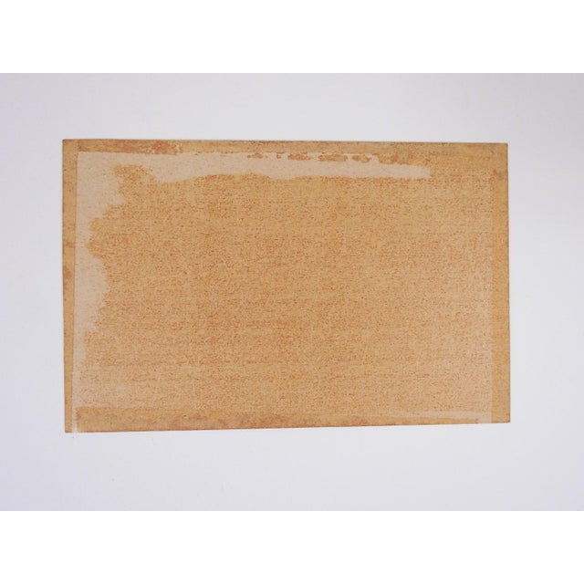 Small early 20th century Asian watercolor painting on card stock of landscape with figure carrying umbrellas under pink...