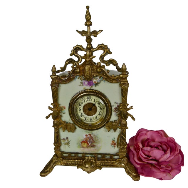 Late 19th-century French mantel clock featuring a hand-painted pale green porcelain case set in an ornate gilt-bronze...