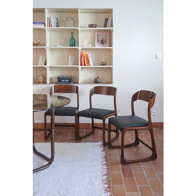 Three Bémol chairs by Baumann, the French maker from Colombier-Fontaine whose sledge-base chair became one of the best-...