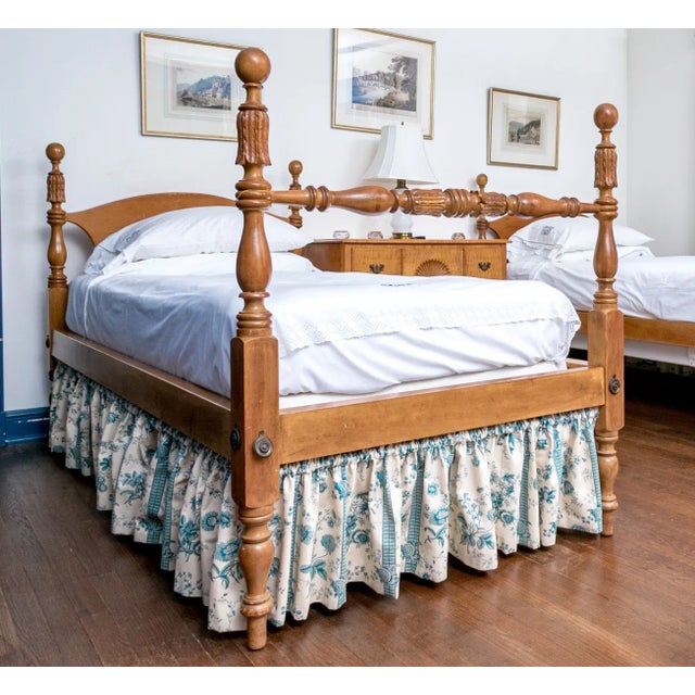 Pair of Early American style maple twin Beds with a hand carved feather design under the cannonballs and on the center of...