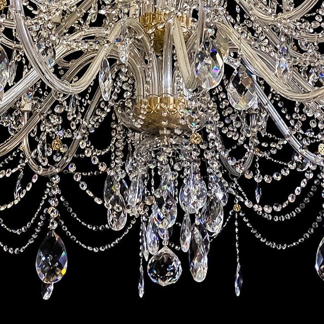 "Mariateresa" chandelier with thirty-eight lights on four orders in golden metal with glass arms, beads and drops. 20th...