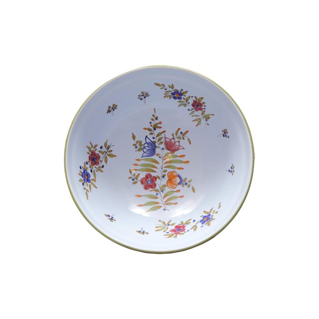 A large Italian ceramic salad bowl. Hand painted with floral sprays in blue and pink over a light blue base. The beveled...