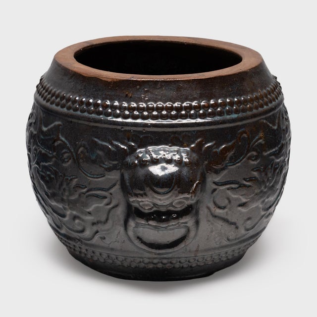 Originally used as a small fish pond, this vintage garden planter has the squat, barrel shape of traditional Chinese opera...