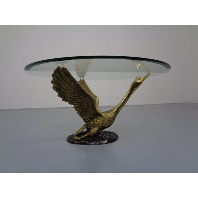 French brass coffee table with a polished, tinted glass top from the 1960s.