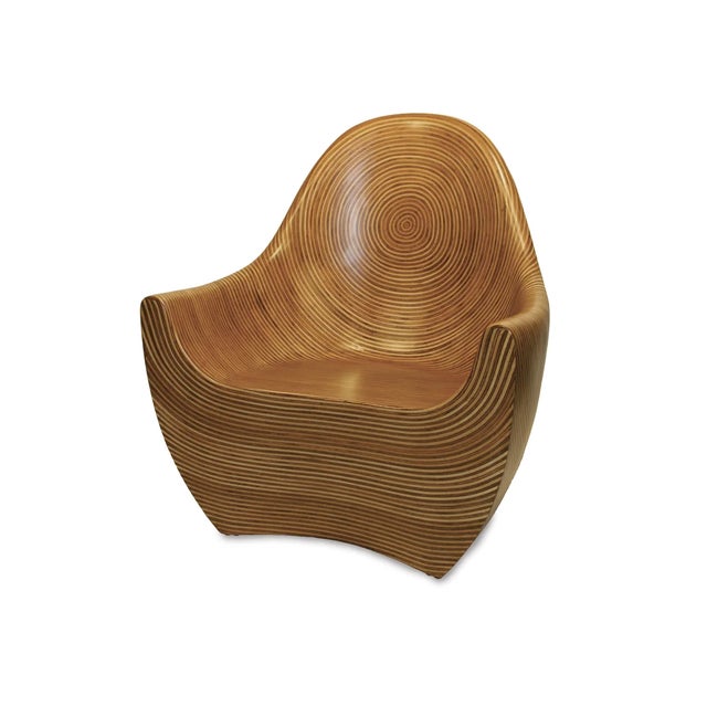 The Regal Occasional Chair showcases Oggetti's Showtime veneer, an intricate arrangement of rattan strips and coconut...
