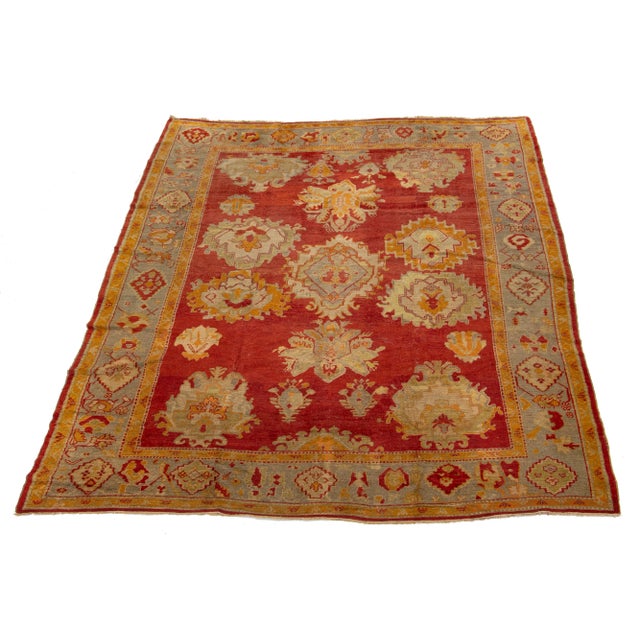 This Turkish Oushak rug is truly one of a kind! It is hand-knotted with soft wool and features a stunning red color field...
