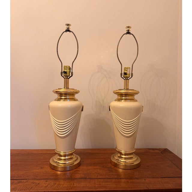 Elevate your space with this gorgeous, matched pair of vintage 1970s/1980s Hollywood Regency urn-form table lamps....