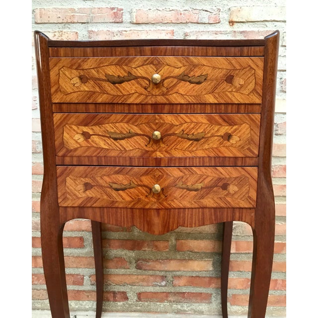 Matching Kingwood Louis XV style nightstands, distinguished from each other in that one has three drawers and the other...