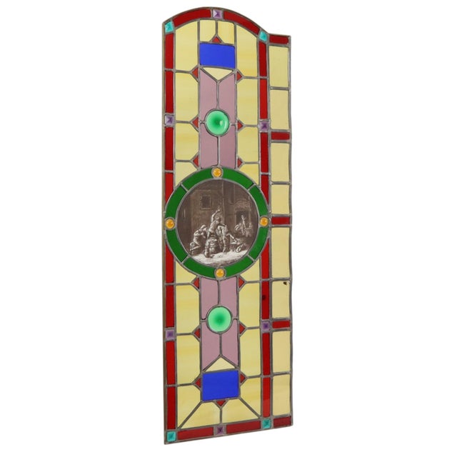 A fantastic, large stained-glass window in a classic style, featuring a central medallion or image depicting a 17th-...