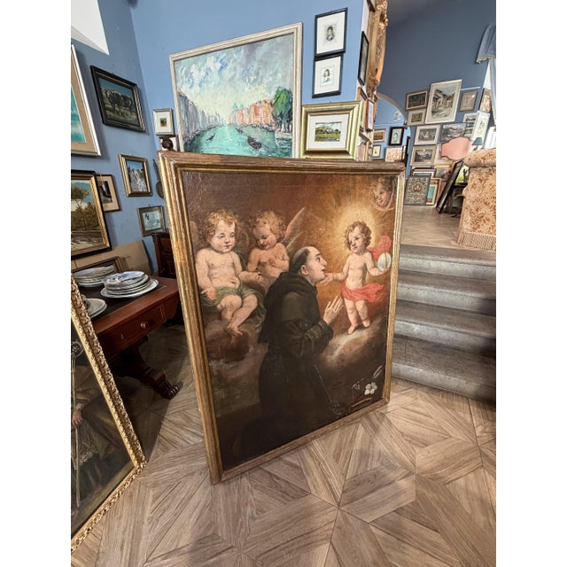Large oil on canvas depicting the Apparition of the Baby Jesus to Saint Anthony of Padua. The painting is rich in classic...