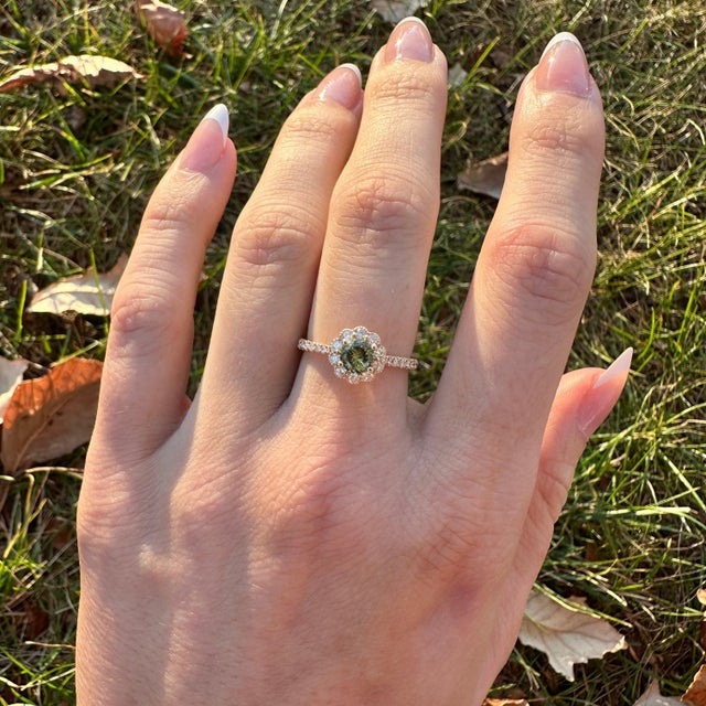 This exquisite ring is a stunning choice for any occasion. Featuring a 0.60 carat Demantoid, it is elegantly surrounded by...