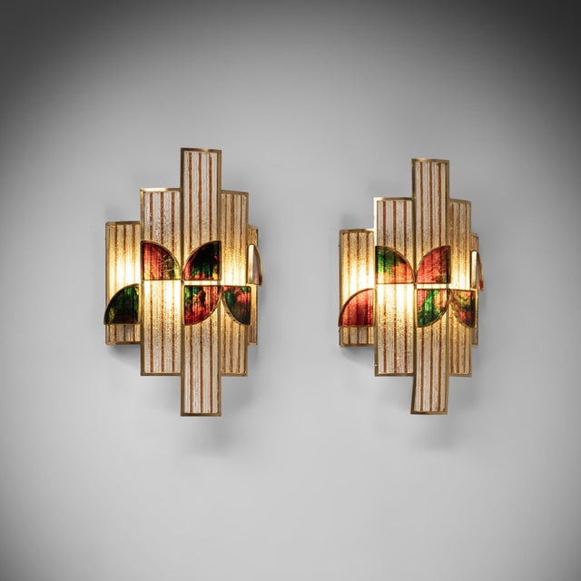 These sculptural wall lamps were designed and manufactured in Italy, during the 1960s. The design combines an...