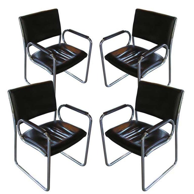 Vintage chocolate brown leather and chrome dining chairs with runner covers for smooth sliding over floors. Very...