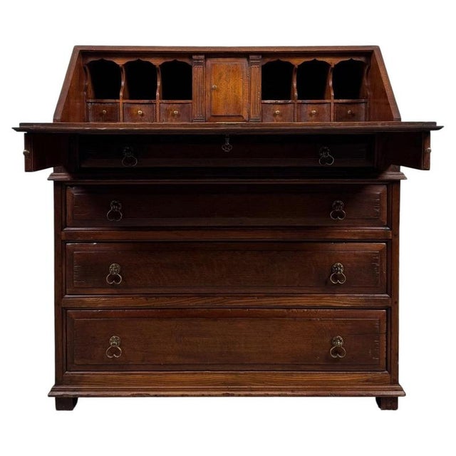 A handsome early 20th-century English bureau, finely crafted from oak and distinguished by its fitted writing interior,...
