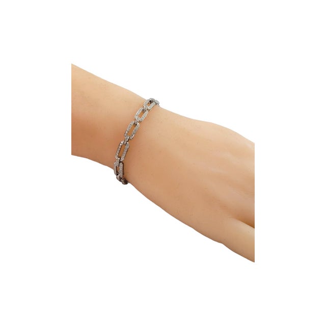 This sparkling bracelet features 221 round brilliant cut diamonds set in classic 18K white gold. Width: 5 mm. Approximate...