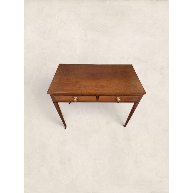 A beautifully proportioned English Victorian writing table, crafted in solid mahogany and dating to circa 1860. Timeless...