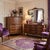 An exceptionally elegant, mid-century French Provincial triple dresser with a matching silhouette wall mirror, masterfully...