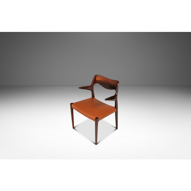 This exceptional set of six rosewood dining chairs by Niels Møller for J.L. Møllers Møbelfabrik combines two of the...