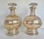Here is an elegant pair of glass decanters with gold, linear stripes. The stoppers are cut glass and have a lovely design...