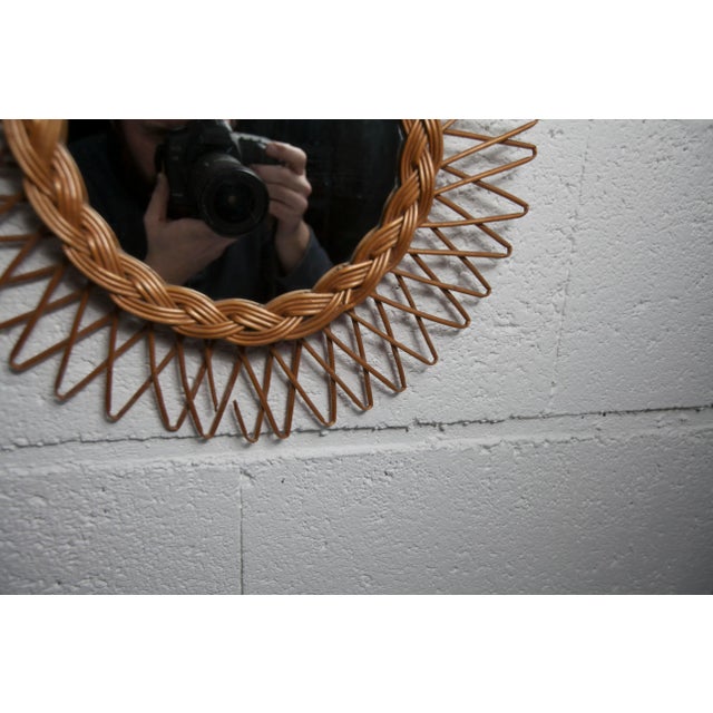 Rattan sun mirror from the 1960s. No scratches on the mirror. One branch broken but the rest is in good condition.