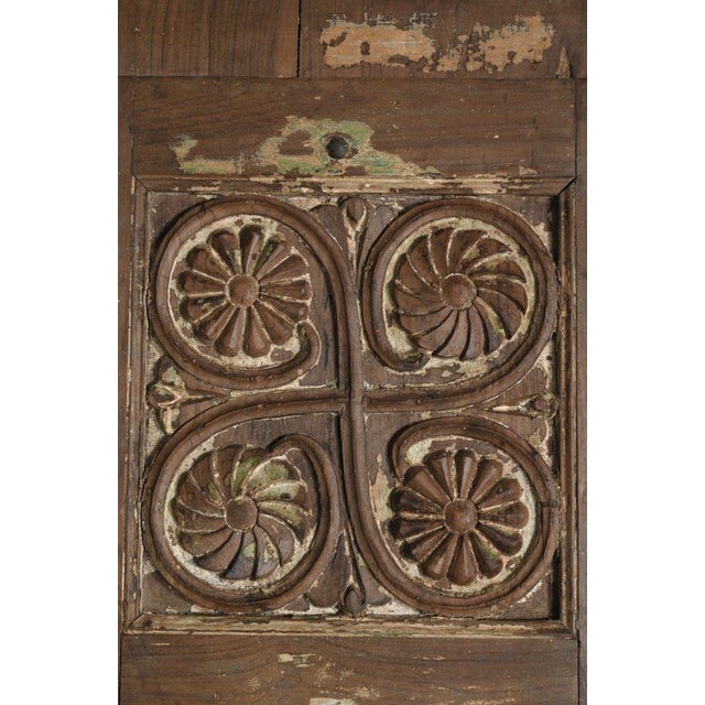 This Antique Anglo-Indian Teakwood Door is crafted from solid teakwood, featuring hand-carved decorative panels with...