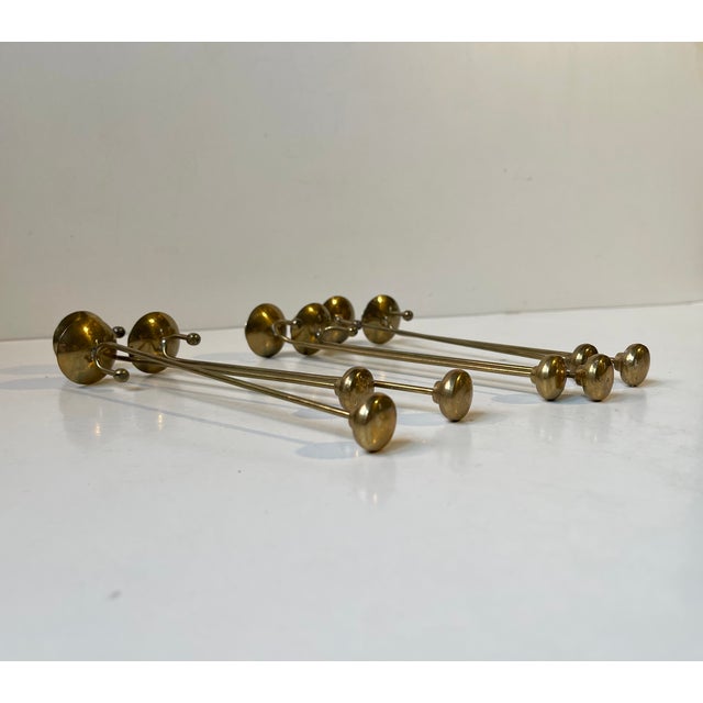 A set of 7 matching pendant/counterweight candleholders in solid brass. Made in Sweden or Denmark during the 1960s. They...