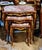 Elegant Rococo style nesting tables featuring a luxurious set of three accent tables topped with sophisticated beige and...