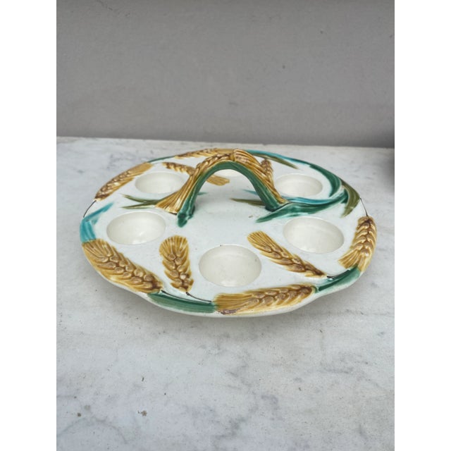 Antique French Majolica wheat egg plate with handle, circa 1900.