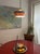 When lit, a warm orange glow spills out from between the nested aluminium bands, scattering across the bubbled glass...