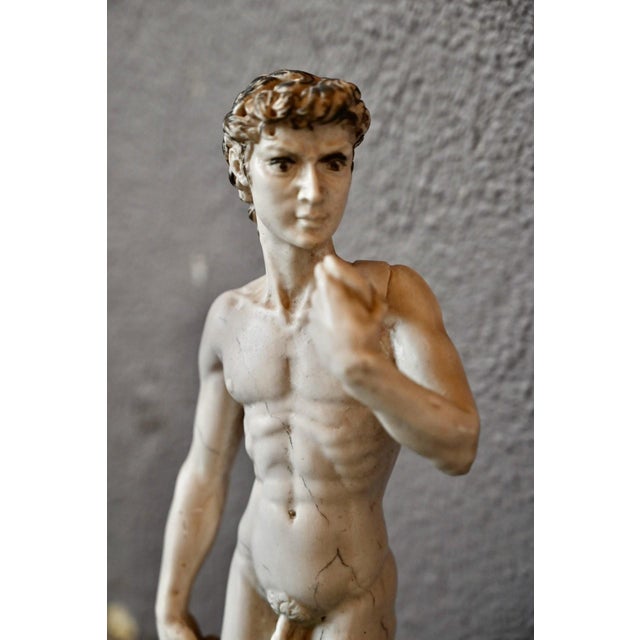 A reproduction of Michelangelo's famous David, this statuette is made of molded plaster with a beautiful finish that...