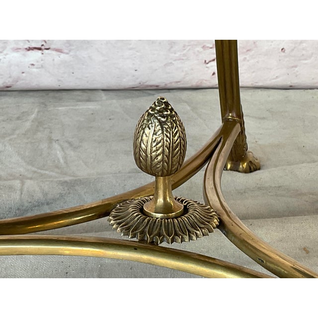 Neoclassical Brass and Black Stone Gueridon Side Table. Table is designed in the French Louis XVI Neoclassical manner. It...