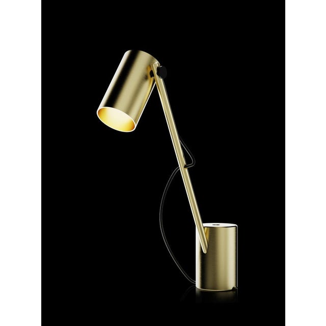 Reconfigurable table lamp with brushed brass structure; solid brushed brass base. Thanks to the two holes on the base, the...