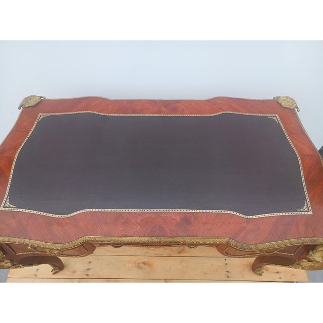 This elegant piece is a French Louis XV style bureau plat, or writing desk, which typically dates from the late 19th to...