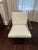 A mid-century-inspired accent chair and matching ottoman from Crate & Barrel's Cavett collection — solid wood frame with...