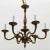 Solid cast bronze chandelier composed of six arms with tendril motif.