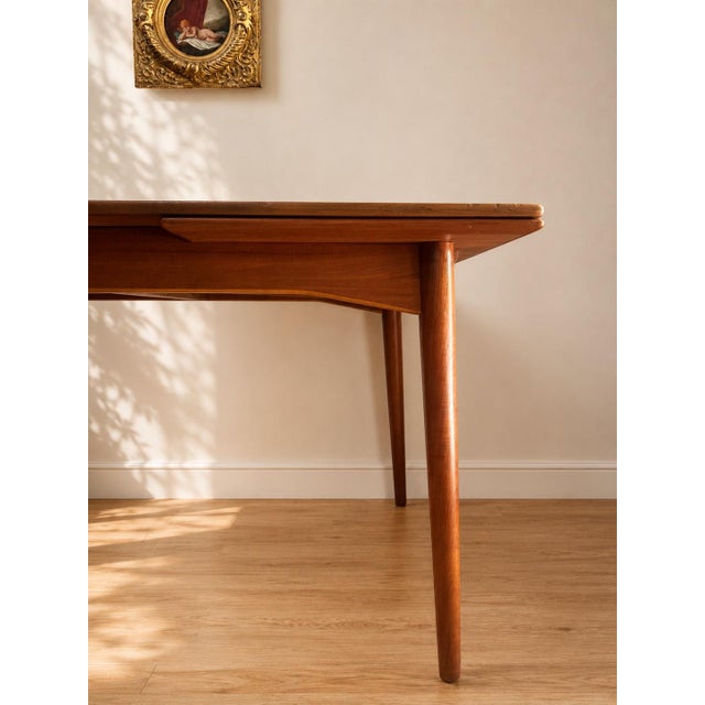Beautiful Danish teak extension dining table by Omann Jun, dating to the 1950s. Designed with the clean proportions and...