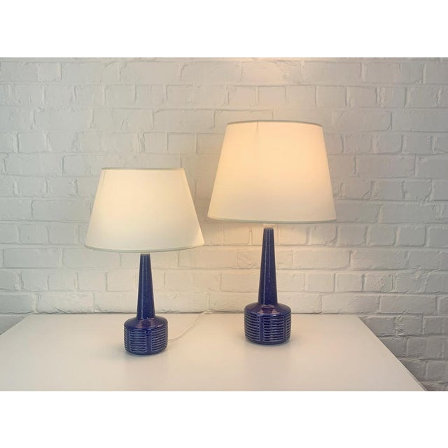 Pair of stoneware table lamps, model dl34 and dl35, produced by palshus (denmark). the lamp bases are finished with a blue...