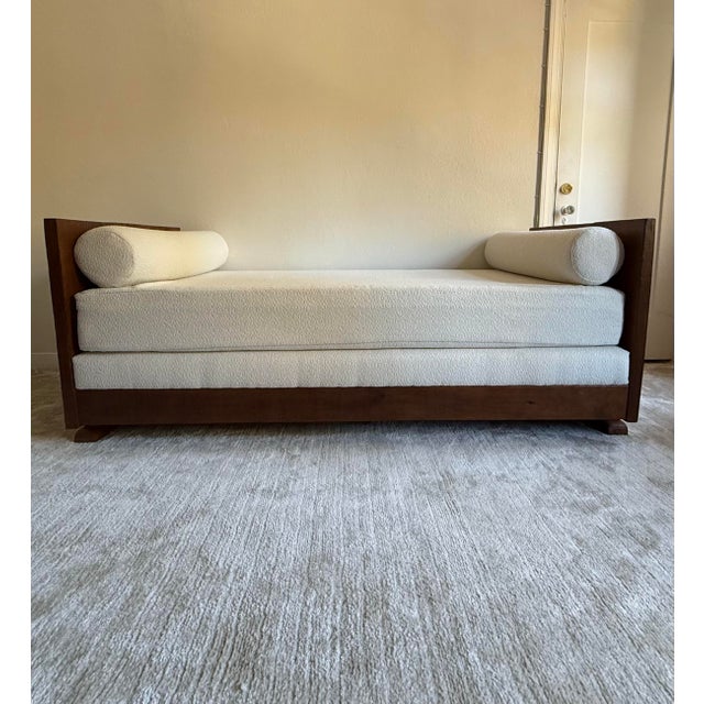 An artist-made craftsman style day bed / chaise longue with bouclé cushions, 21st century. This piece was designed by...