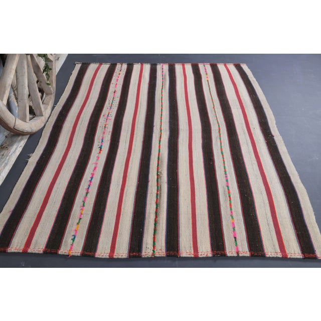 Vintage Turkish Hand-Knotted vintage rug is a semi-Vintage kilim area rug.'70s Eastern region of Turkey's unique rug is...