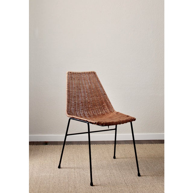 A charming original Basket Chair designed by Gian Franco Legler in 1951. The chair features a handwoven rattan seat shell...