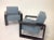 Modern pair of lounge chairs. Chairs are done in a blue chenille. The finish is a dark chocolate. The frames are made of...
