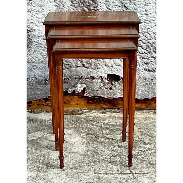 Charming set of three vintage Regency nesting tables, each hand-painted with delicate details and finished in a rich,...