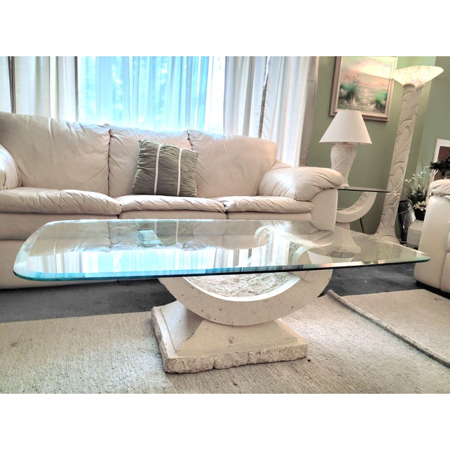 Postmodern sculptural natural Mactan stone coffee table. Circa 1980s. Sculptural postmodern pedestal with a contrasting...