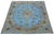 This antique Persian wool rug features a medallion floral design in light blue with beige and brown accents, all hand-...