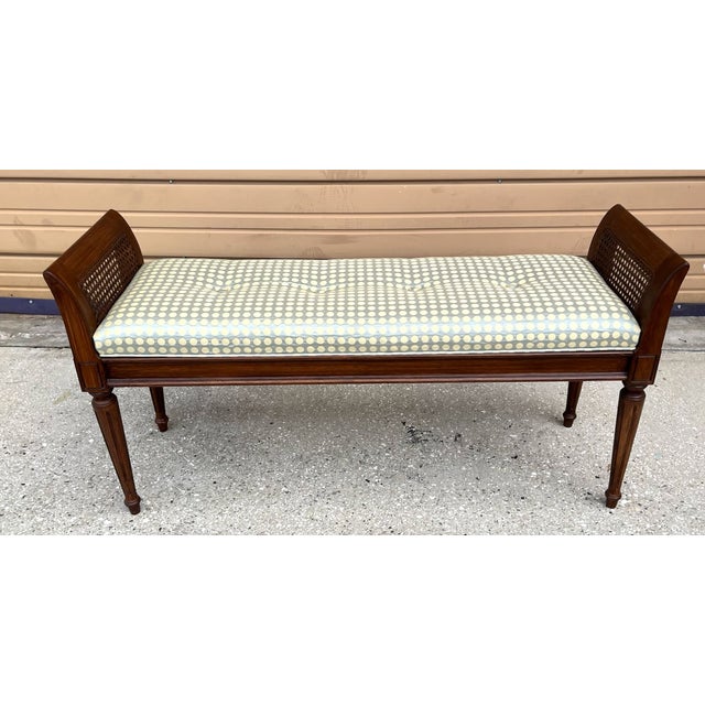 A hard to find narrow bench with caned arms. This wooden bench has gently curved arms with cane sides and tapered, fluted...