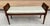 A hard to find narrow bench with caned arms. This wooden bench has gently curved arms with cane sides and tapered, fluted...