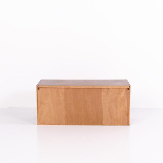 Wall-mounted cabinet crafted from rosewood with sliding doors. The cabinet was made in the 1960s and provides interior...