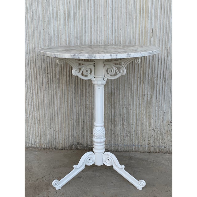 About French style cast iron base with marble top garden table or bistro table. Finely detailed cast iron base with white...