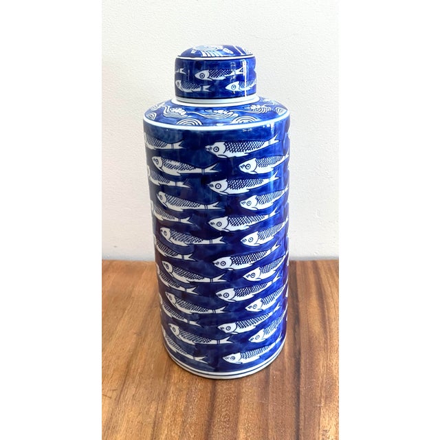 Schoal Blue and White Ceramic Fish Detail Lidded Ginger Jar, a Chinoiserie-style decorative vessel featuring a striking...